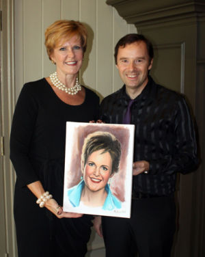 Sergey Malina painting a portrait of Erin Davis during The Art of Fashion event